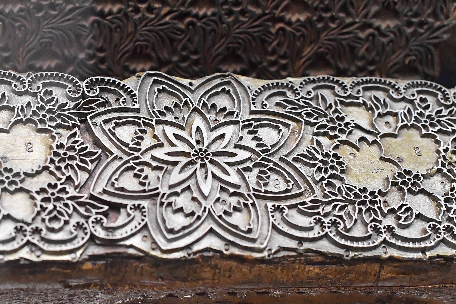 Close-up of a hand-carved wooden textile printing block.