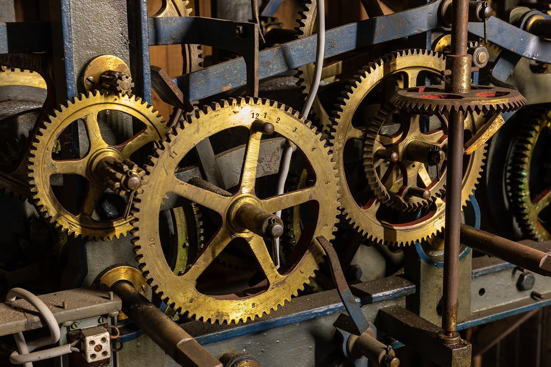 Brass gear wheels in the movement of a mechanical tower clock.